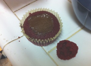 Cutting a hole in the top of the cupcake to insert chocolate